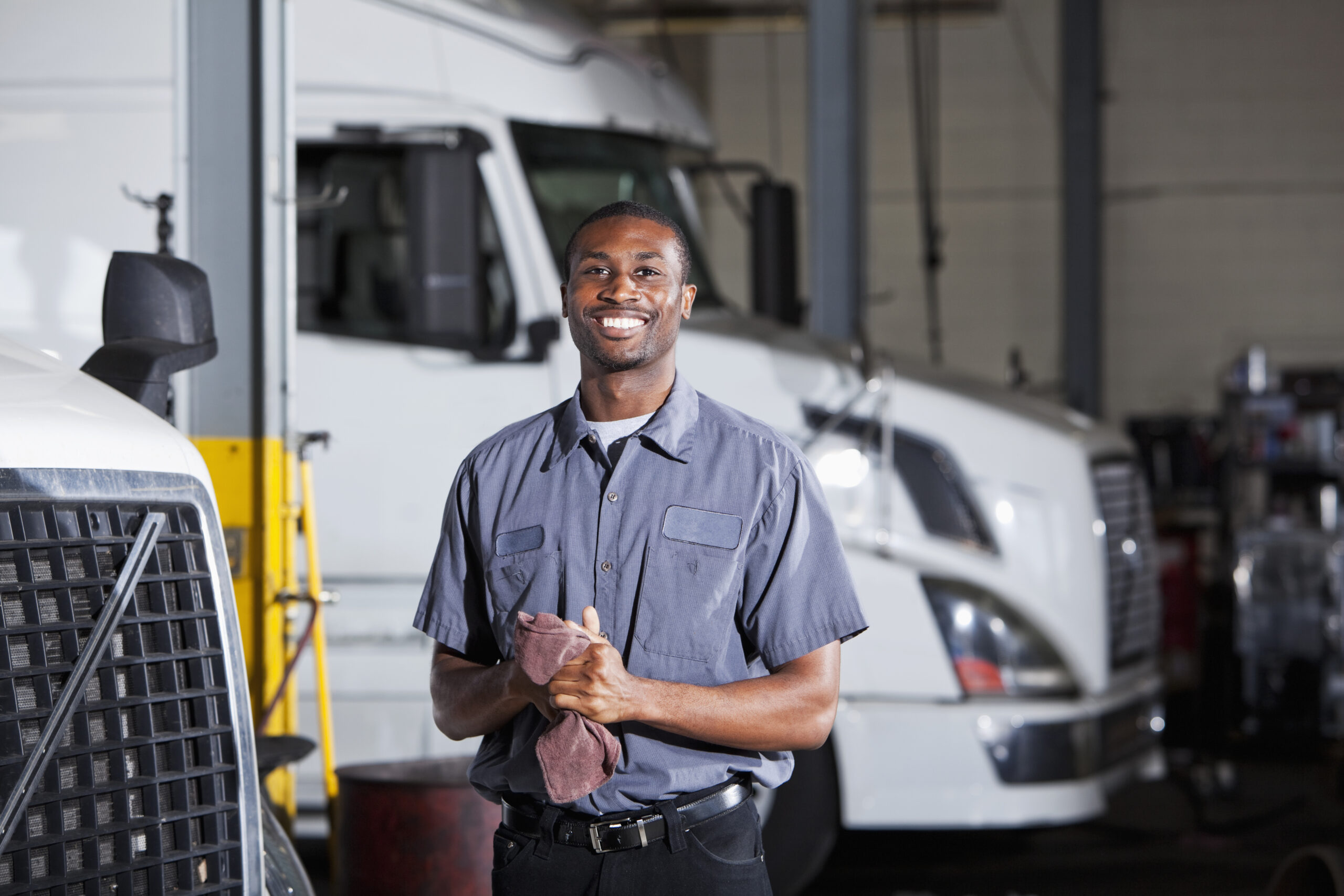 Mechanic In Garage With Semi Truck