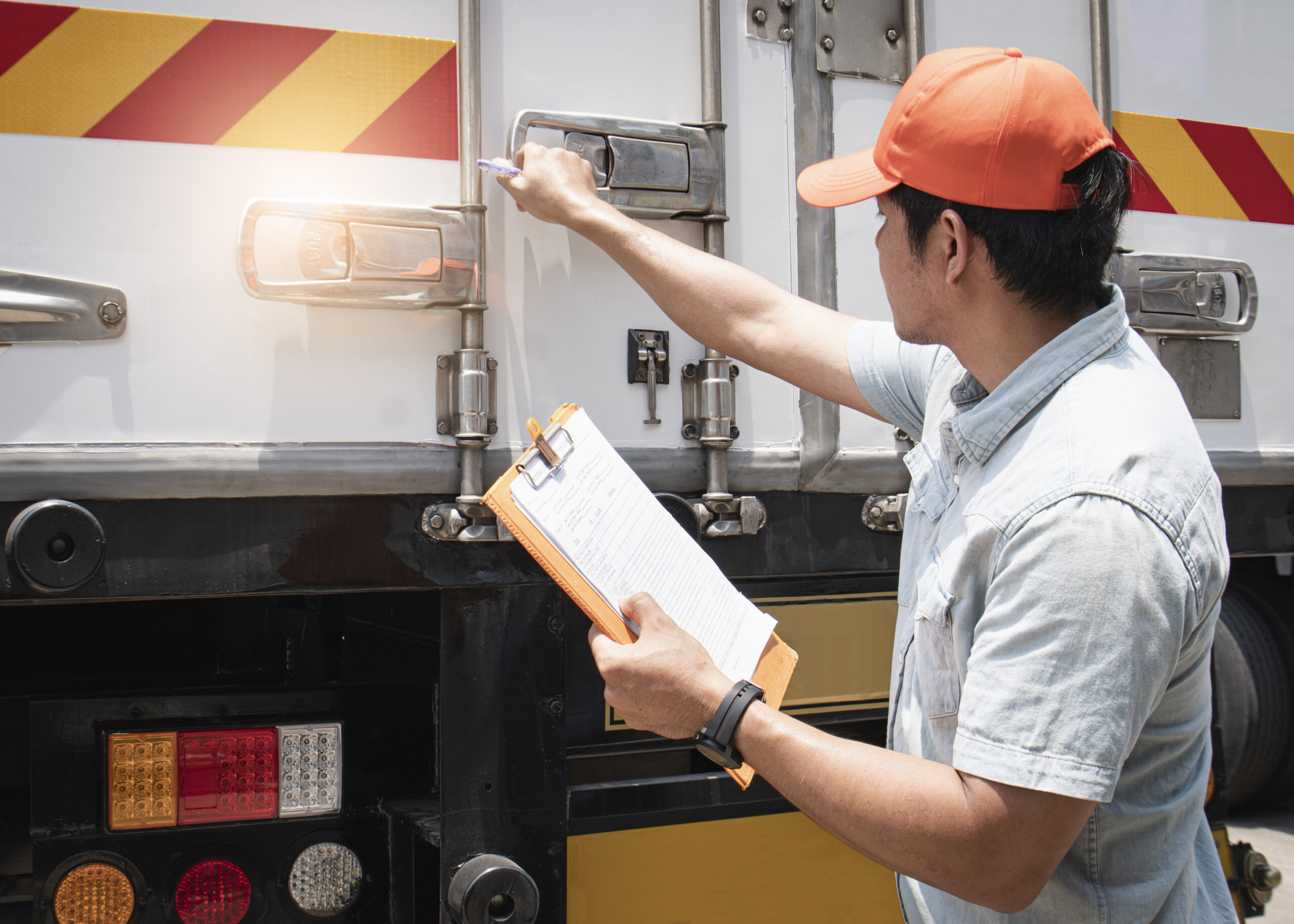 Asian A Truck Driver Holding Clipboard His Checking Safety Cargo Container Steel Door.