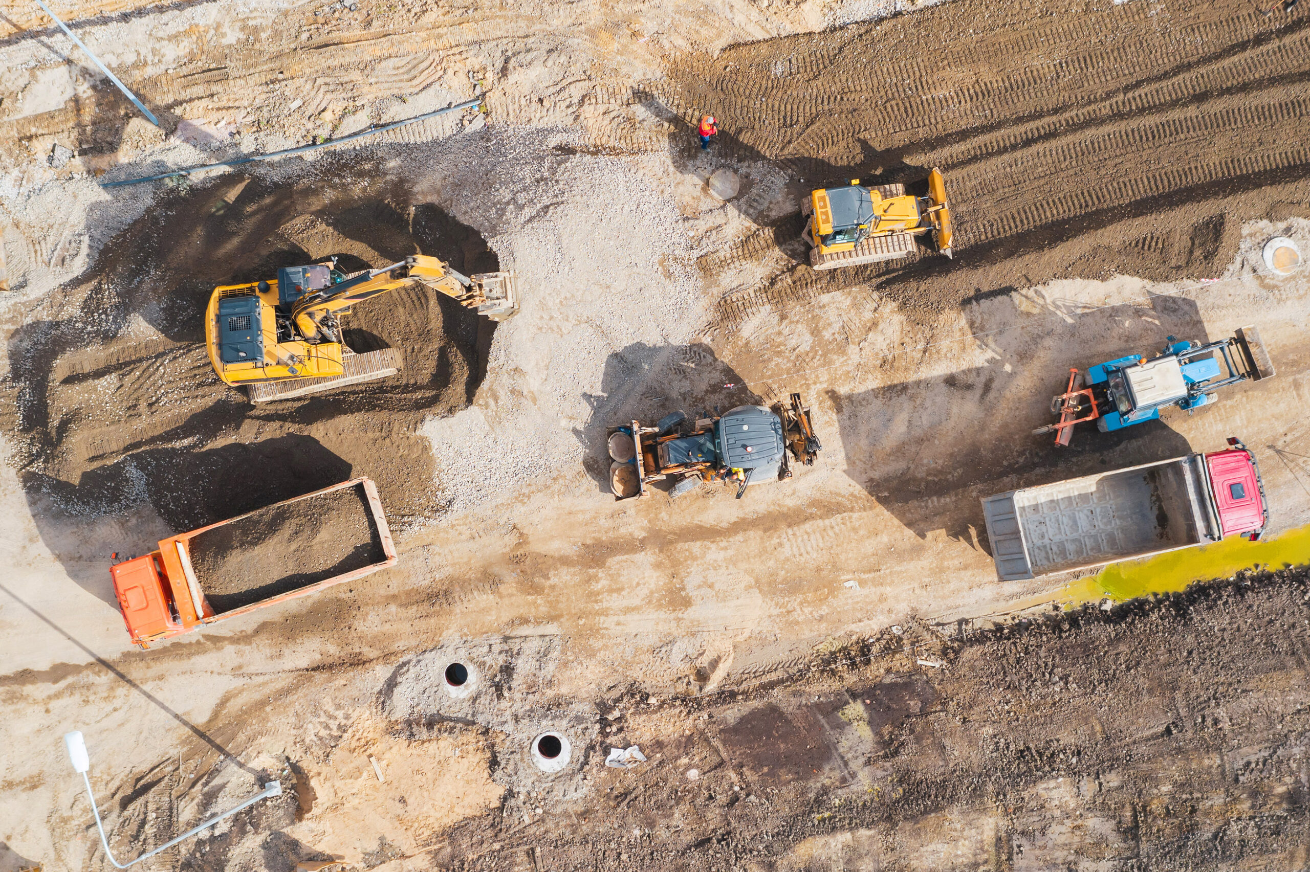 Construction Of A City Street, Laying Of Communications, Installation Of Sewer Hatches, Gutters, Curbs. Preparation For Paving, Aerial View.
