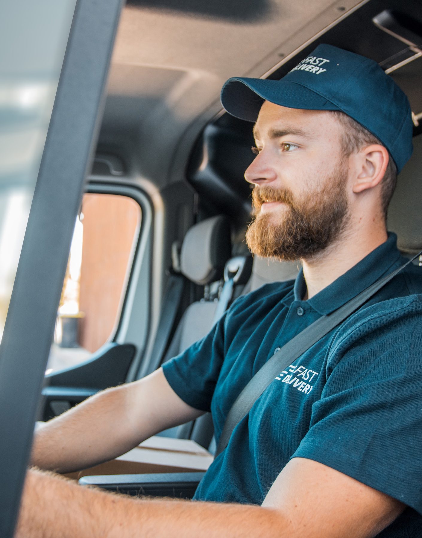 Commercial fleet driver wearing a seat belt inside a vehicle