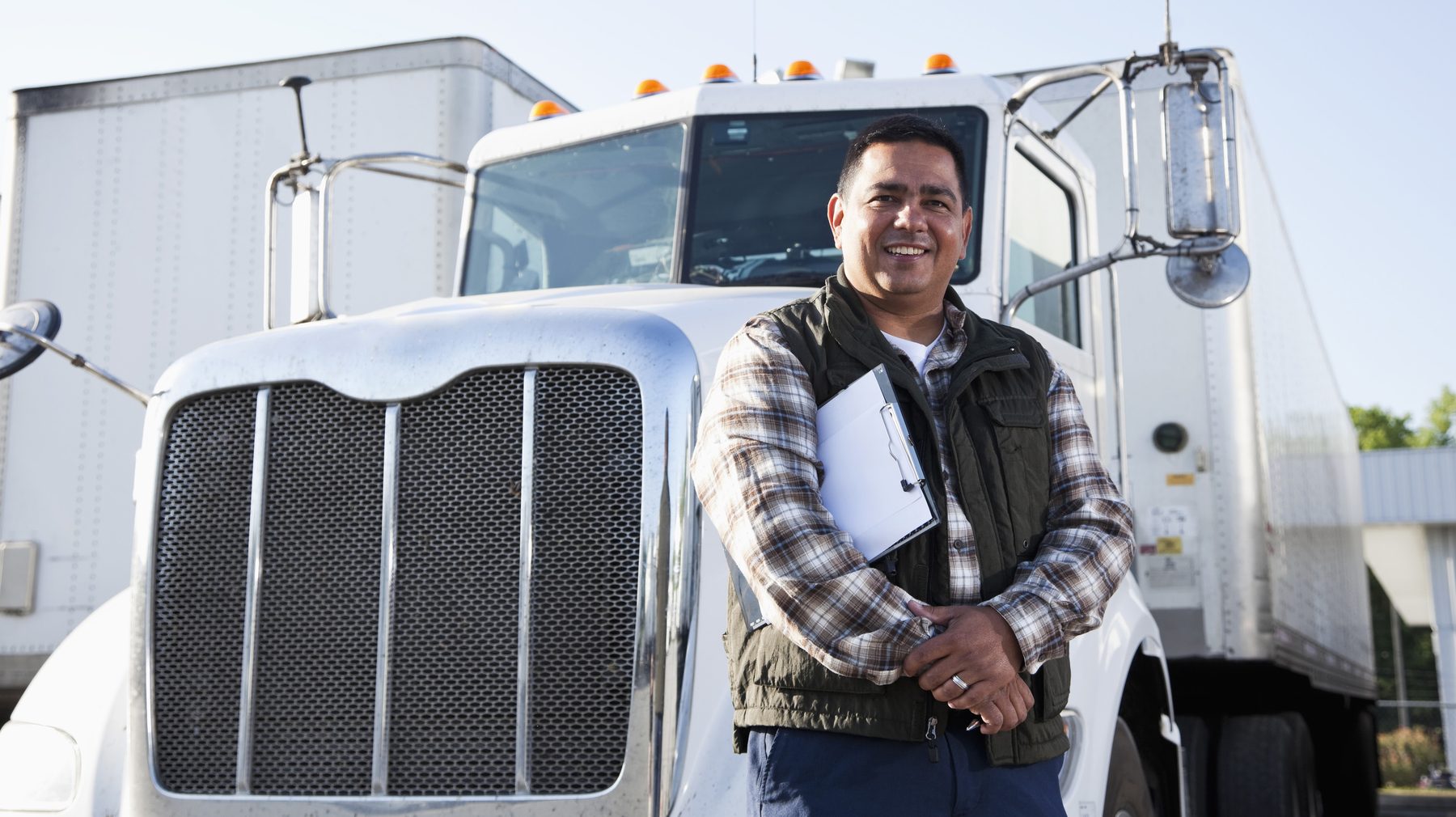 Fleet professional standing in front of a commercial truck